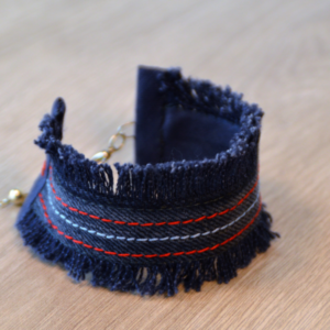 Upcycled denim bracelet with red and white details by KOLLIB