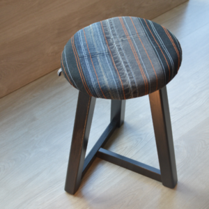 Upcyled denim stool with wood legs painted in black by KOLLIB