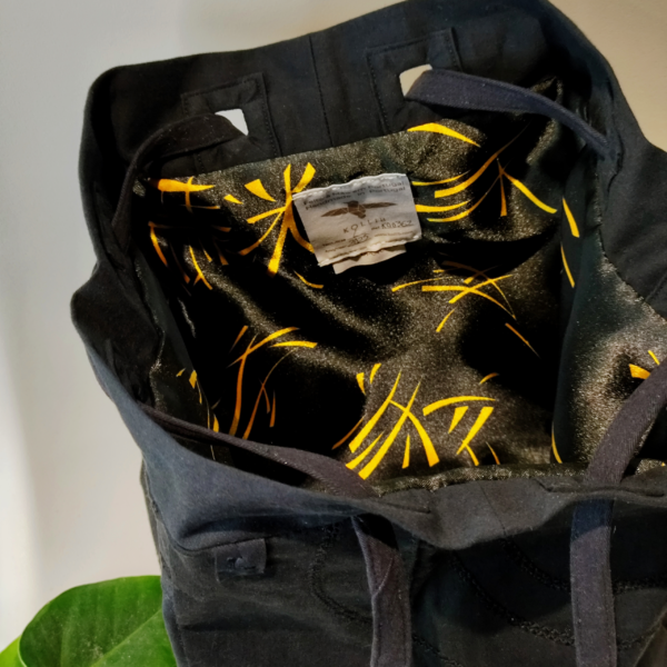 Inside view of a KOLLIB black upcycled denim bohemian style backpack.